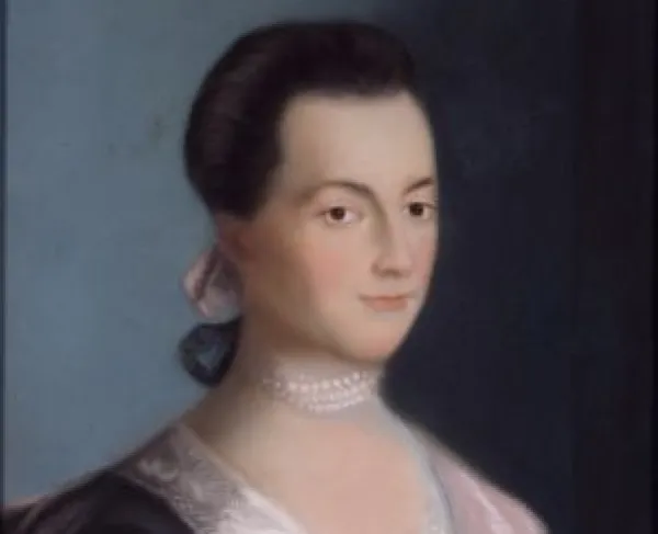 Portrait of a woman in a blue dress with a pearl necklace. 
