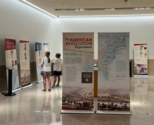 Visitors peruse the American Revolution Experience traveling exhibit on display at the Virginia State Capitol in June 2024.