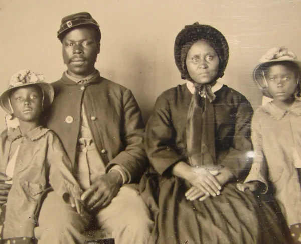 Unidentified African American soldier in Union uniform with wife and two daughters